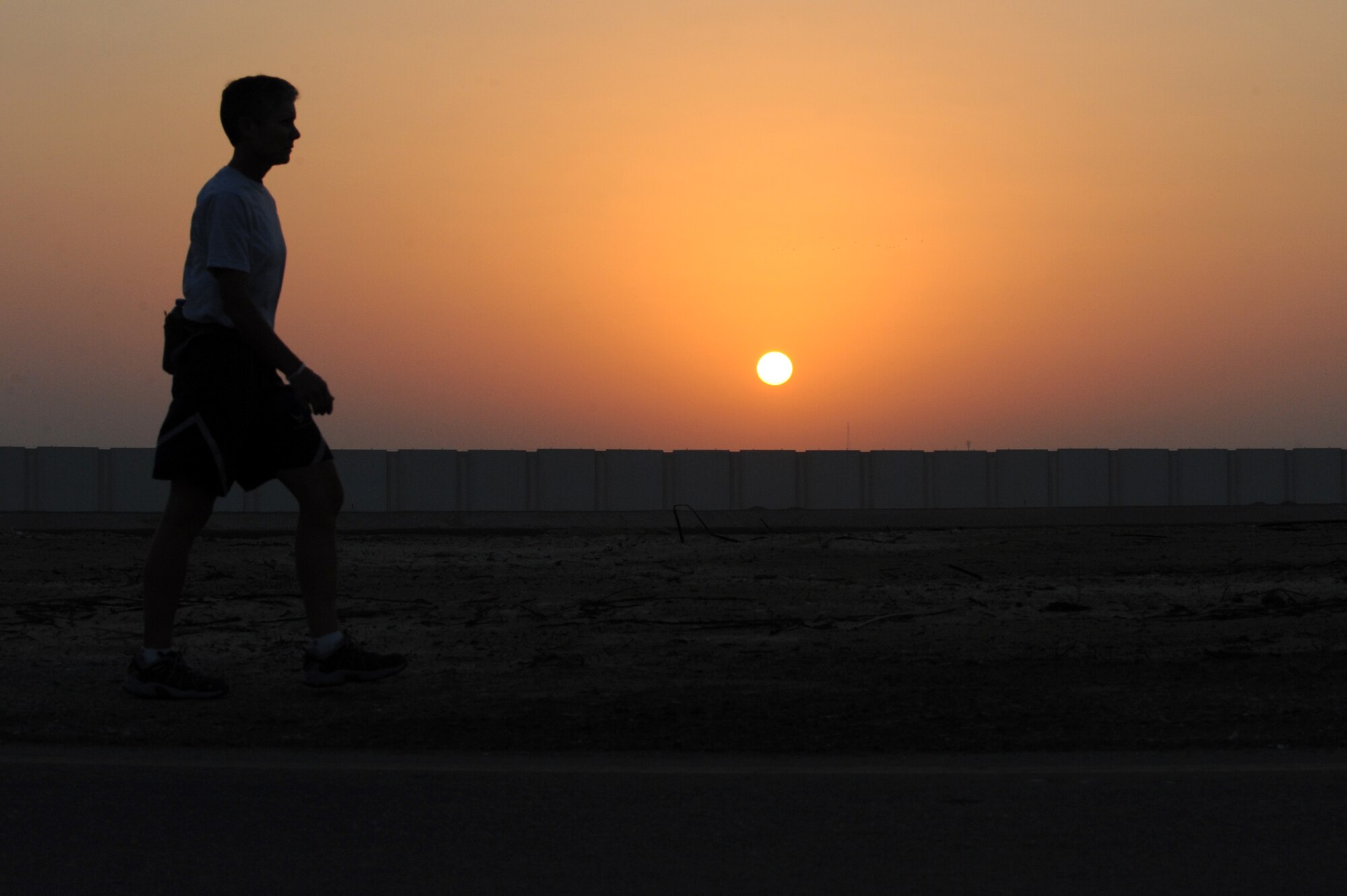 SOUTHWEST ASIA - U.S. Air Force Master Sgt. Laurie Cherry, 727th Expeditionary Air Control Squadron first sergeant, is up walking at sunrise, training for the Susan G. Komen three-day walk for breast cancer research and awareness Oct. 17, 2012. Cherry is training to walk 60 miles over three days Nov. 9-11 in support of the event.  (U.S. Air Force photo/Master Sgt. Scott MacKay)