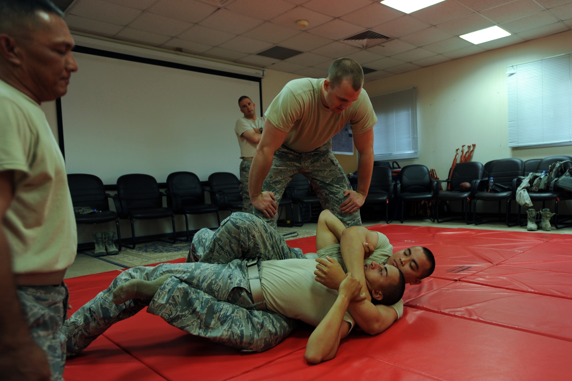 U.S. Air Force Staff Sgt. Darren Elison, 379th Expeditionary Security Forces Squadron training instructor, watches a student attempt to secure a near-naked choke during a combative class in Southwest Asia, Oct. 16, 2012. During the class, participants were taught a variety of basic escape techniques, offensive strikes, weapons retention and physical restraint holds. (U.S. Air Force photo/Staff Sgt. Sheila deVera)
