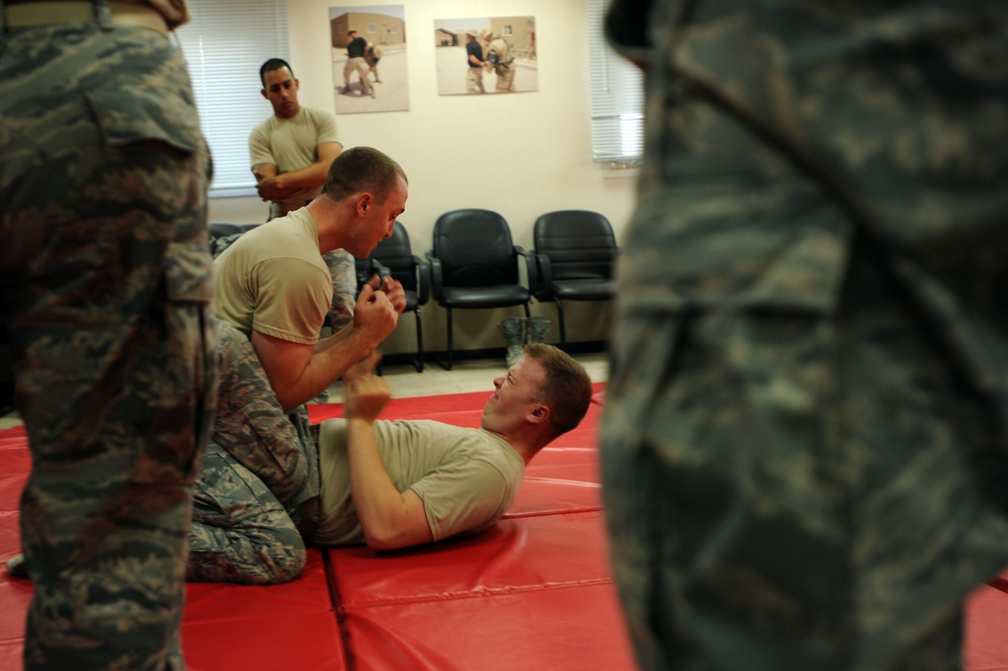 U.S. Air Force Staff Sgt. Darren Elison, 379th Expeditionary Security Forces Squadron training instructor, demonstrates how to pass the guard during a class in Southwest Asia, Oct. 16, 2012. During the class, participants were taught the proper way to strike and grapple during hand-to-hand combat situation. Elison is deployed from the 75th Security Forces Squadron, Hill Air Force Base, Utah. (U.S. Air Force photo/Staff Sgt. Sheila deVera)
