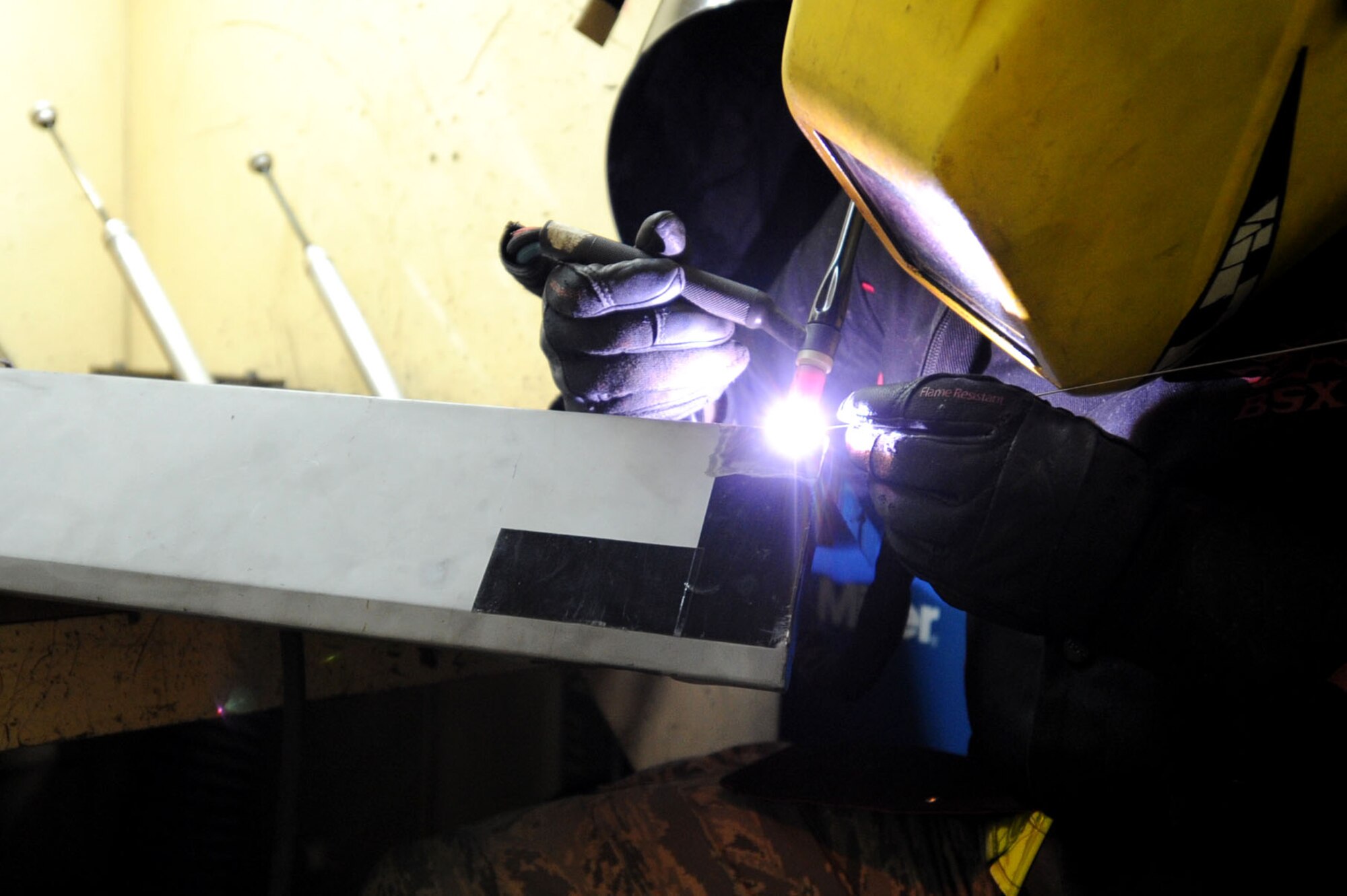 U.S. Airman 1st Class Jonathan Miller, 18th Equipment Maintenance Squadron aircraft metal technician, welds a piece of metal on Kadena Air Base, Japan, Oct. 18, 2012. The unit provides metal work for all the aircraft on Kadena. (U.S. Air Force photo/ Airman 1st Class Brooke P. Beers)