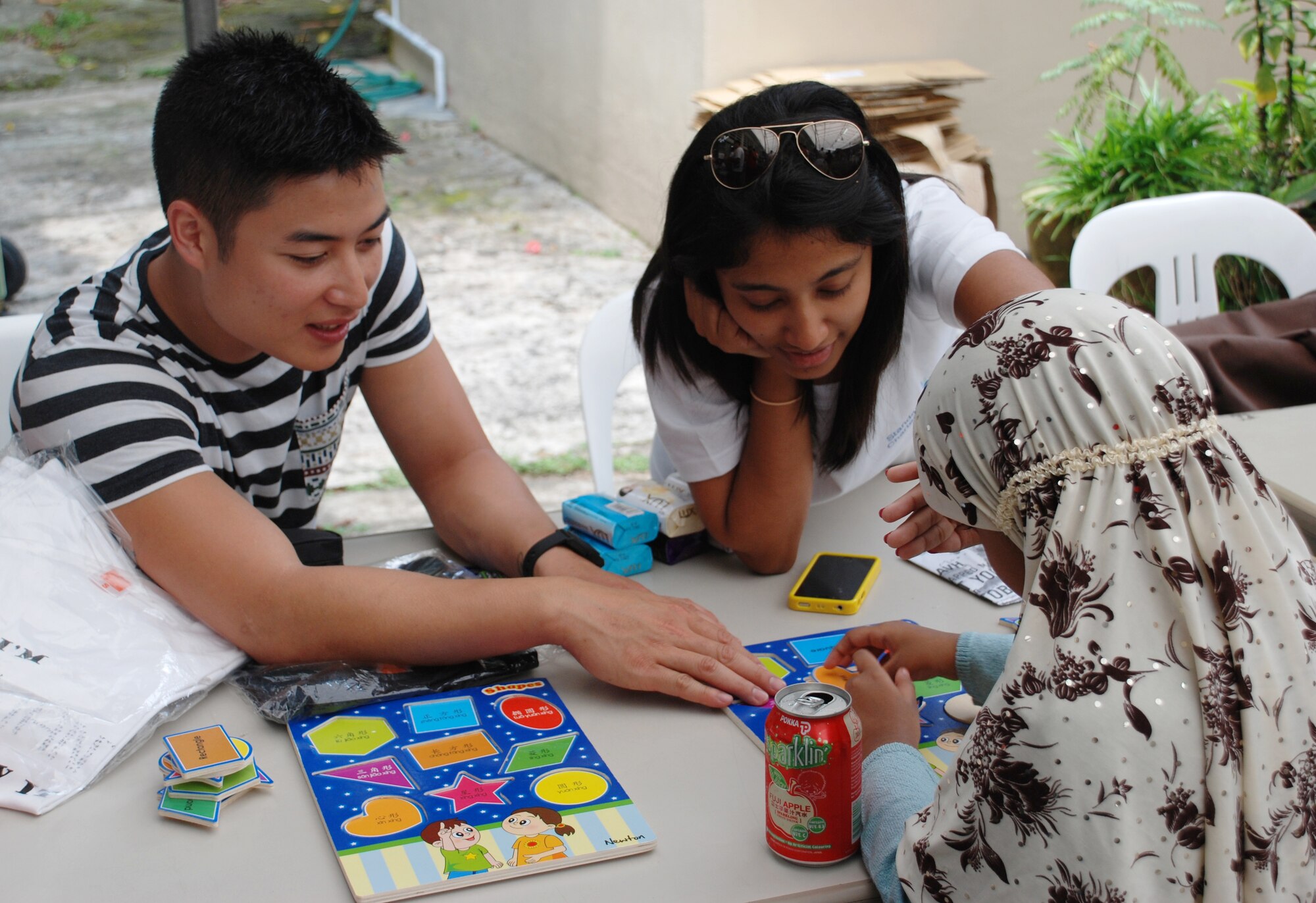Staff Sgt. Anou Souvannavong, 51st Maintenance Squadron F-16 sheet metal specialist, served as a role model during his time at the game station during White Cane Day in the Republic of Singapore, Oct. 13, 2012. Airmen from the 36th Fighter Squadron teamed up with the local community in Singapore to raise money and volunteer time to support the visually handicapped during their off-time from combined exercise Commando Sling. (Courtesy photo)