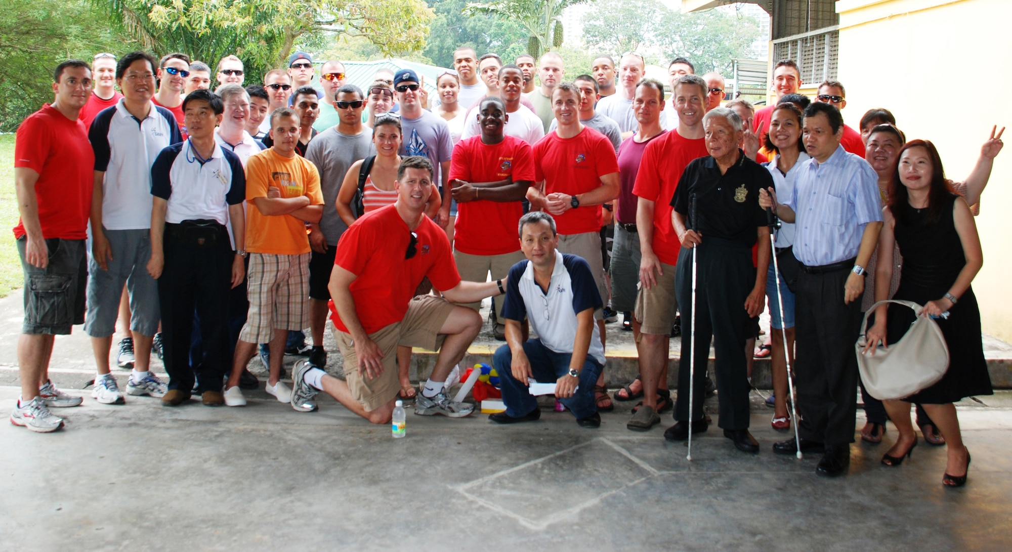 The 36th Fighter Squadron ‘Fiends’ pose for a photo with the Singapore Association for the Visually Handicapped, Chen Su Lan Methodist Children's Home, and Blind Faith, Oct. 13, 2012, while volunteering with the local Singapore community on White Cane Day. (Courtesy photo)
