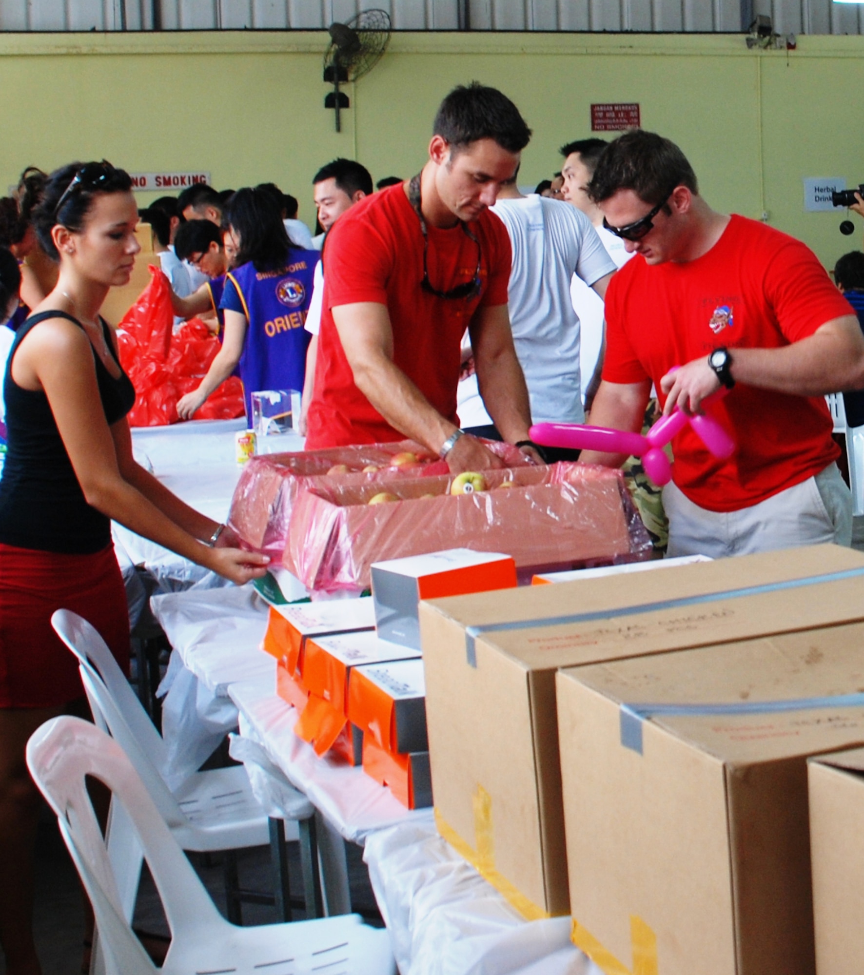1st Lt. James Byrd and his wife, Melissa, along with 1st Lt. Jacob Bass, and Capt. Eric Emerson helped sell donated food items on White Cane Day in Singapore, Oct. 13, 2012. Airmen from the 36th Fighter Squadron teamed up with the local community in Singapore to raise money and volunteer time to support the visually handicapped during their off-time from combined exercise Commando Sling. Byrd is the 36th FS mission planning officer, Bass is the 36th FS assistant chief of plans, and Emerson is the 36th FS daily scheduler.  (Courtesy photo)