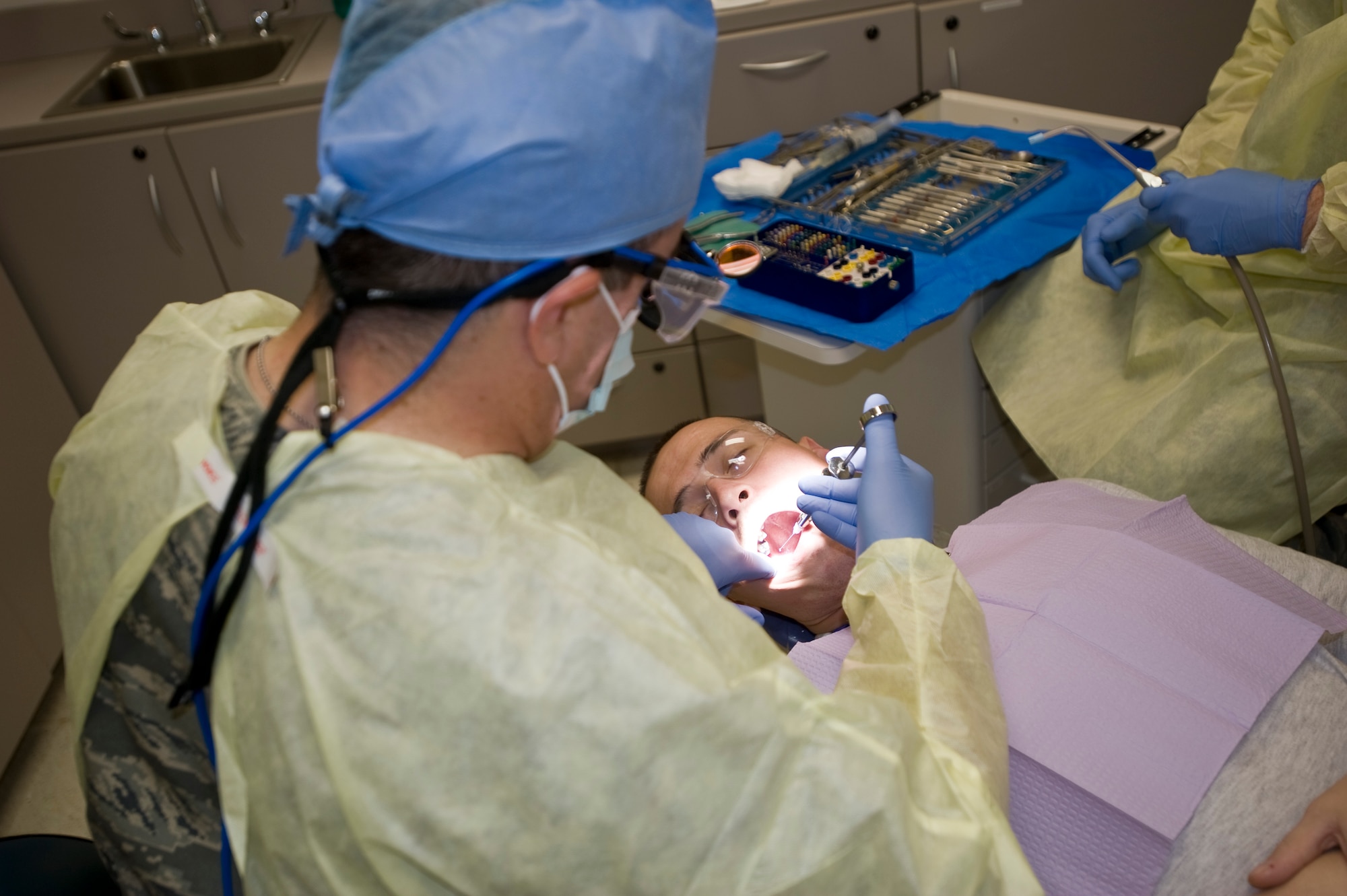 Senior Airman Joe Spears, 379th Expeditionary Bomb Squadron beyond line of sight weapons specialist, receives a local anesthesia from Lt. Col. Philip Barone, 379th Expeditionary Medical Group dentist, before his dental procedure to fill a cracked tooth Oct. 16, 2012. The three-man dental team sees approximately 150 patients a month for a variety of dental issues. Some patients simply require a custom fitted mouth guard while others may need a temporary crown due to a lost tooth. (U.S. Air Force photo/Senior Airman Bryan Swink)