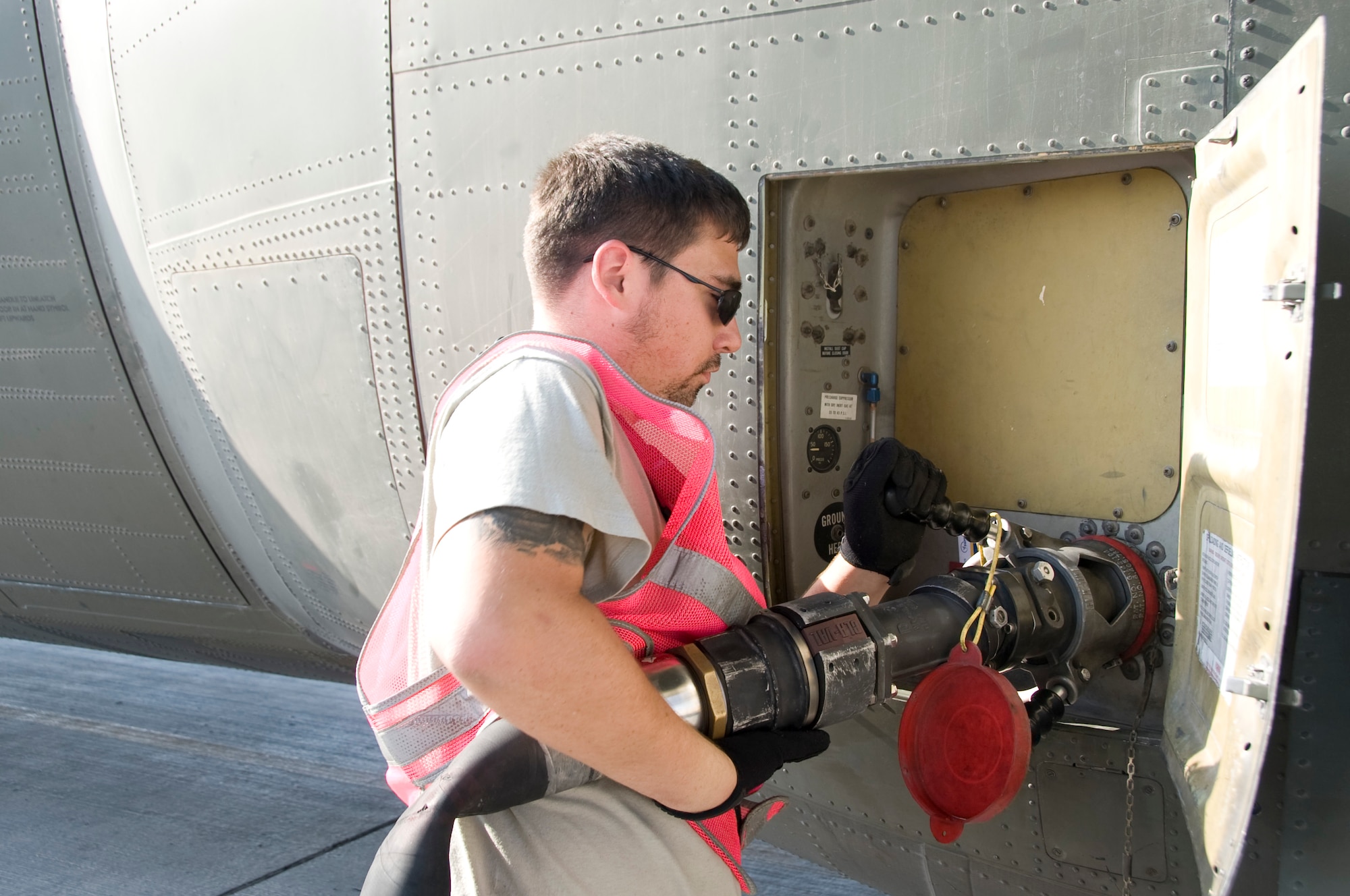 William Brandt, 379th Expeditionary Maintenance Squadron Transient Alert maintenance technician, attaches a fuel hose to a Royal Air Force C-130 Hercules after its arrival at the 379th Air Expeditionary Wing Oct. 11, 2012. Brandt, and the other contractors assigned to Transient Alert, are former loadmasters and crew chiefs who served in the military. Their vast knowledge of different aircraft provides a valuable resource in handling the many different airframes that pass through the 379th AEW. (U.S. Air Force photo/Senior Airman Bryan Swink)