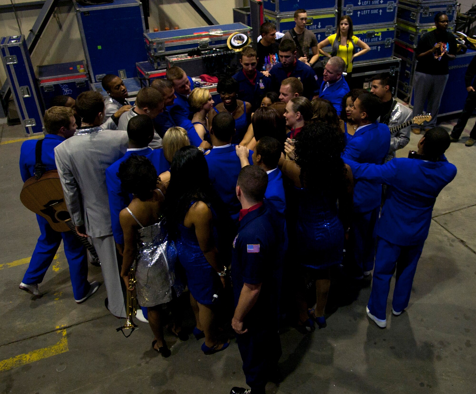 Tops in Blue performers and technical directors gather for their final pep talk before the show begins at Incirlik Air Base, Turkey, Oct. 13, 2012. This year’s Tops in Blue tour took audience members on a musical journey through time and various artists from The Doobie Brothers and Mariah Carey to Maroon 5 and Darius Rucker. (U.S. Senior Airman Daniel Phelps/Released)