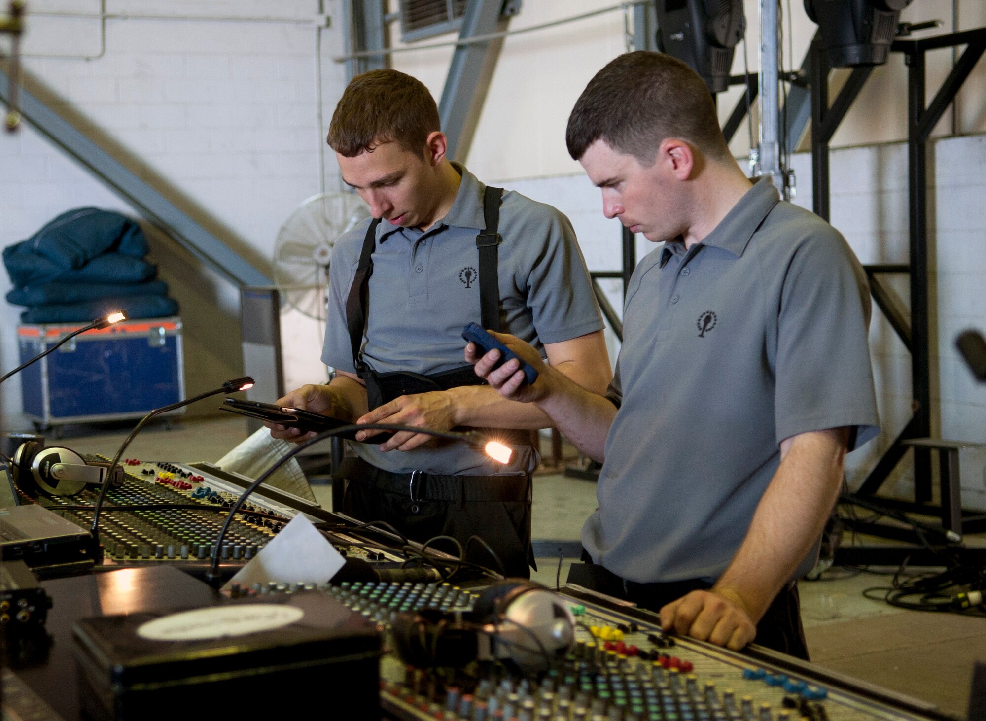 Senior Airman Julian Saviano, 10th Intelligence Squadron cyber transportation systems journeyman and Tops in Blue audio director, and Senior Airman Roger Payne, 20th Component Maintenance Squadron avionics test station journeyman and Tops in Blue audio engineer, test the settings on the light and sound boards at Incirlik Air Base, Turkey, Oct. 13, 2012. The cast and crew of Tops in Blue set up and tear down the stage, lighting and sound equipment for every show. (U.S. Senior Airman Daniel Phelps/Released)