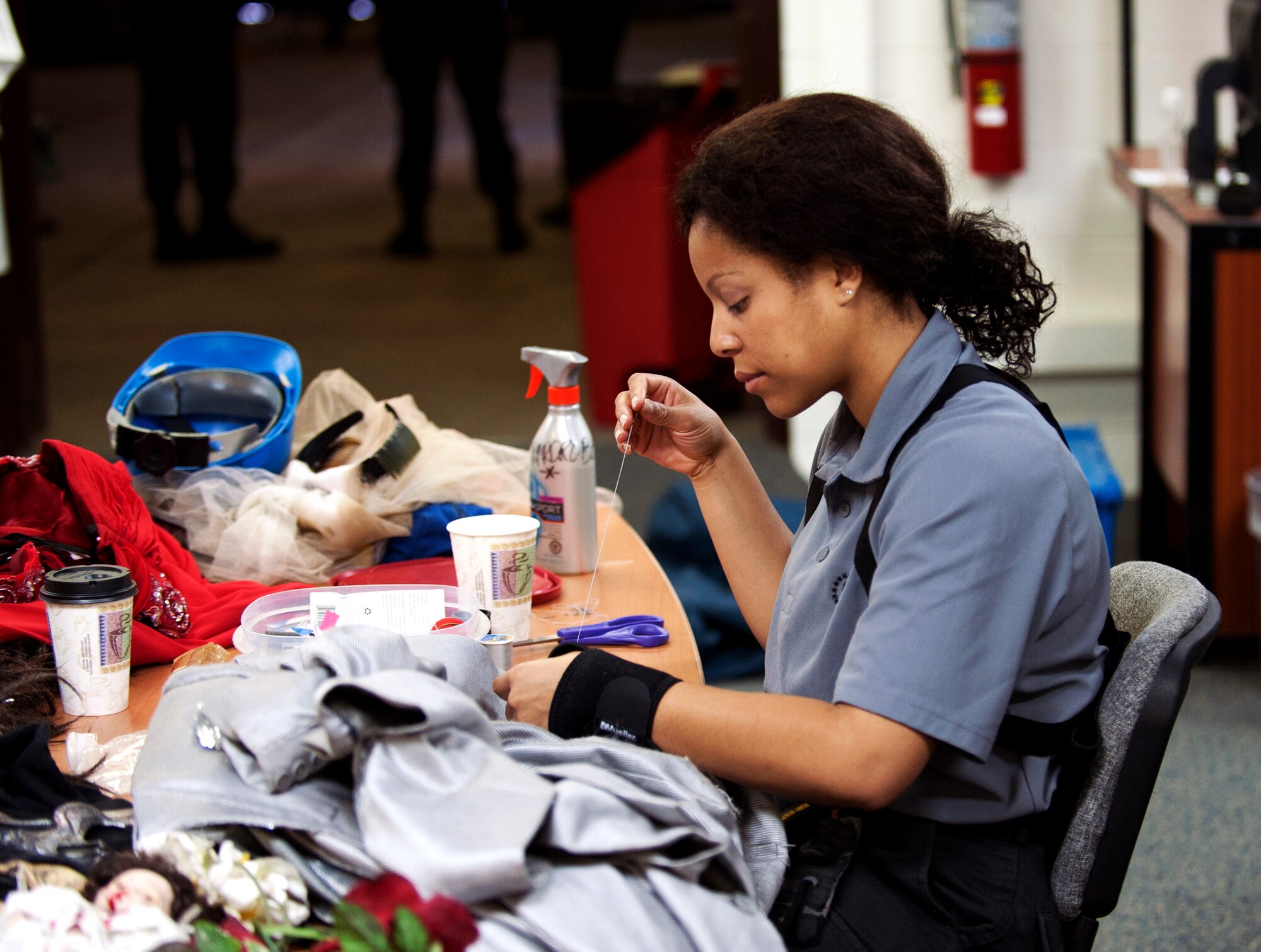 1st Lt. Kandis Rich, 705th Combat Training Squadron acquisition officer and Tops in Blue vocalist, sews costumes in preparation for the evening’s concert at Incirlik Air Base, Turkey, Oct. 13, 2012. During a 10-month time period Tops in Blue members travel to more than 20 countries perform nearly 130 shows. (U.S. Senior Airman Daniel Phelps/Released)