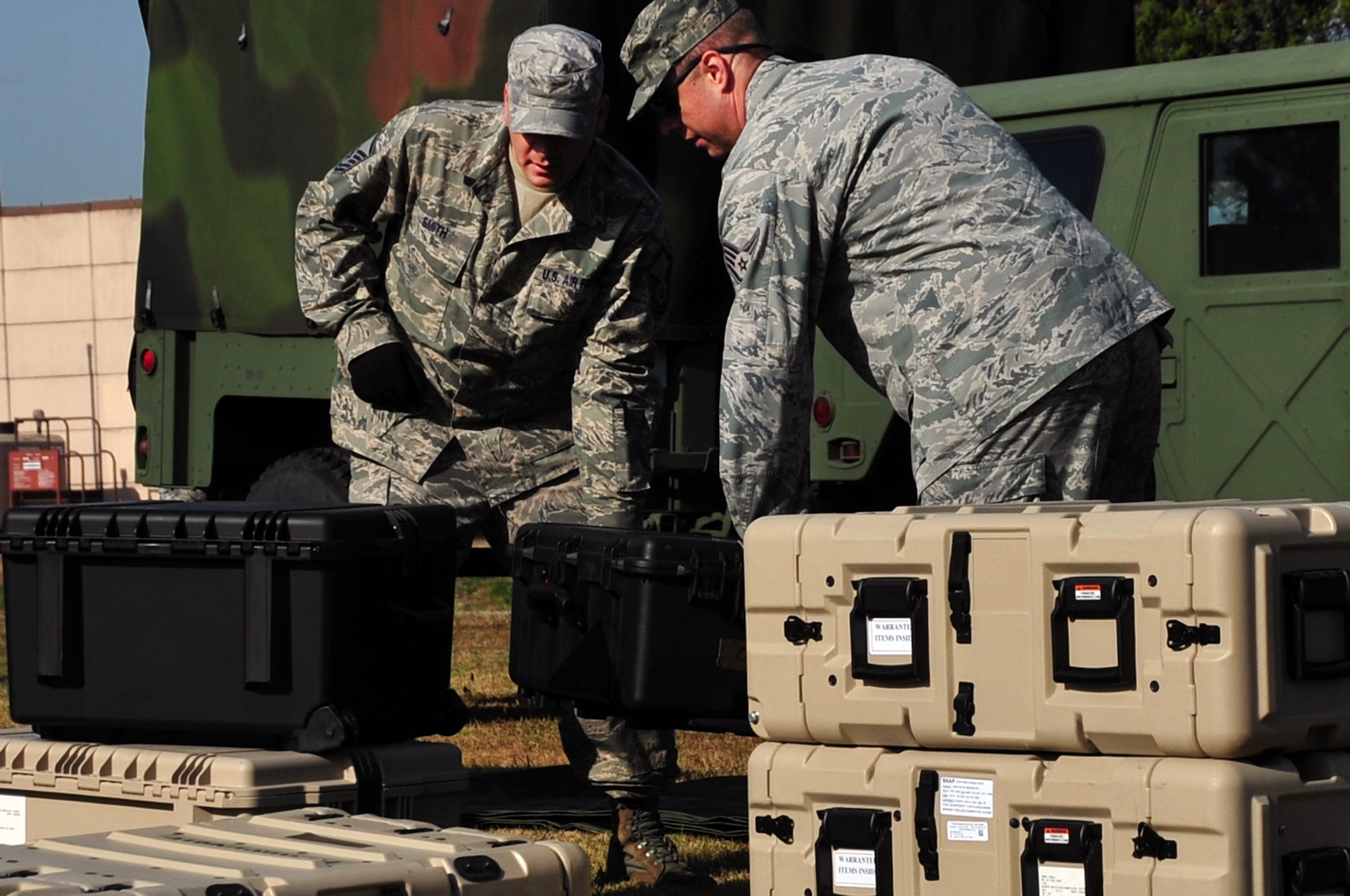 Master Sgt. Bradley Smith, 607th Air Support Operations Group support
flight superintendent, and Staff Sgt. Christopher Richey, 607th ASOG
logistics, unload communications cargo at Osan Air Base, Republic of Korea,
Oct. 15, 2012. Smith and Richey were participating in a training day of
field operations in preparation of an upcoming peninsula exercise. (U.S. Air
Force photo/Staff Sgt. Craig Cisek)
