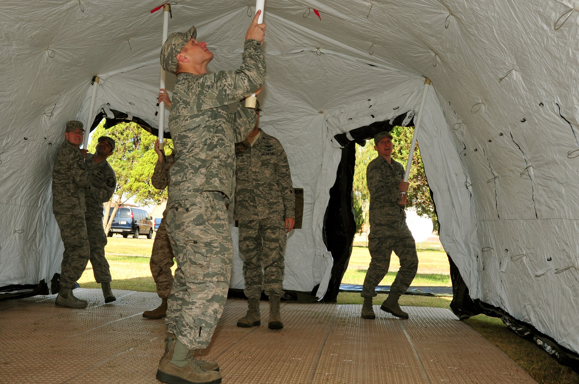 Airmen from the 607th Air Support Operations Group push stand up a tent
at Osan Air Base, Republic of Korea, Oct. 15, 2012. The Airmen set up their
gear in preparation of an upcoming peninsula exercise. (U.S. Air Force
photo/Staff Sgt. Craig Cisek)
