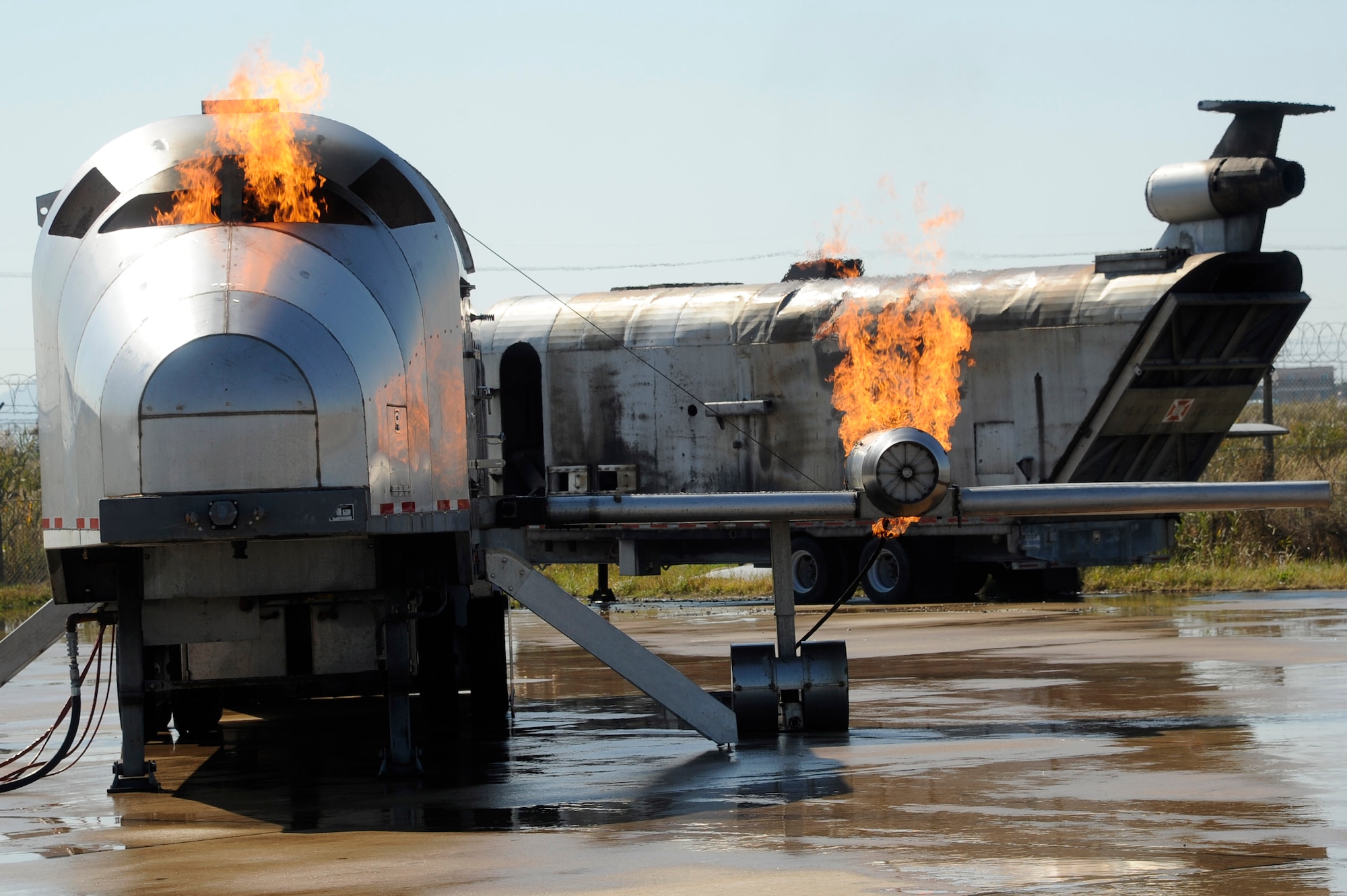 An aircraft trainer is set on fire for the U.S. Air Force 8th Civil Engineer Squadron and Republic of Korea 38th Fighter Group firefighter training at Kunsan Air Base, Republic of Korea, Oct. 16, 2012. Both forces worked on aiming the boom and driving the crash response vehicle to effectively fight the fire. (U.S. Air Force photo/Senior Airman Marcus Morris)