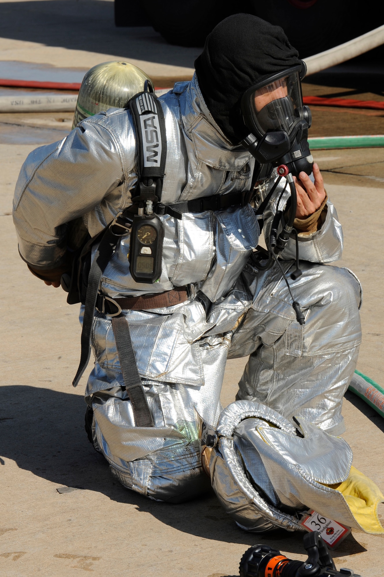 Kim Kyong Min, 8th Civil Engineer Squadron firefighter, removes his gears after completing training at Kunsan Air Base, Republic of Korea, Oct. 16, 2012.  Aircraft fire training is completed quarterly. (U.S. Air Force photo/Senior Airman Marcus Morris)
