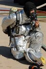 Kim Kyong Min, 8th Civil Engineer Squadron firefighter, removes his gears after completing training at Kunsan Air Base, Republic of Korea, Oct. 16, 2012.  Aircraft fire training is completed quarterly. (U.S. Air Force photo/Senior Airman Marcus Morris)