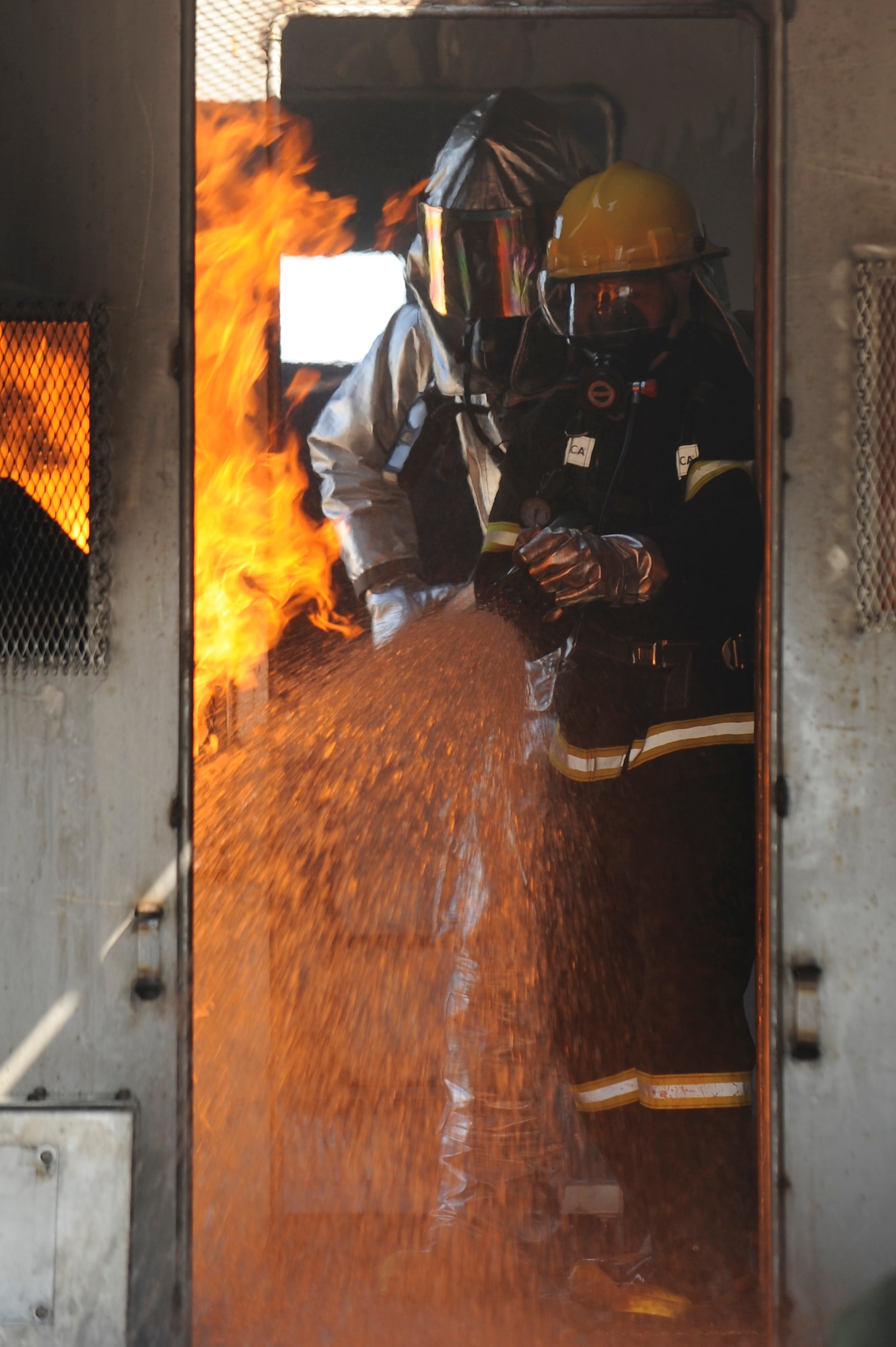 Staff Sgt. Timothy Vanden Haak, 8th Civil Engineer Squadron, left, and a member of Republic of Korea Air Force 38th Fighter Group firefighters work together to put out a fire on an aircraft trainer at Kunsan Air Base, Republic of Korea, Oct. 13, 2012. Firefighters also trained to shut off the aircraft to prevent the ejector seats from causing damage to the pilot or others. (U.S. Air Force photo/Senior Airman Marcus 