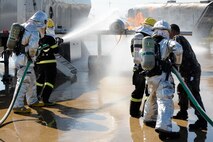 Members from the U.S. Air Force 8th Civil Engineer Squadron and Republic of Korea Air Force 38th Fighter Group firefighters put out a fire on an aircraft trainer at Kunsan Air Base, Republic of Korea, Oct. 16, 2012. This was the first time  USAF and ROKAF worked together during their firefighter training. (U.S. Air Force photo/Senior Airman Marcus Morris)