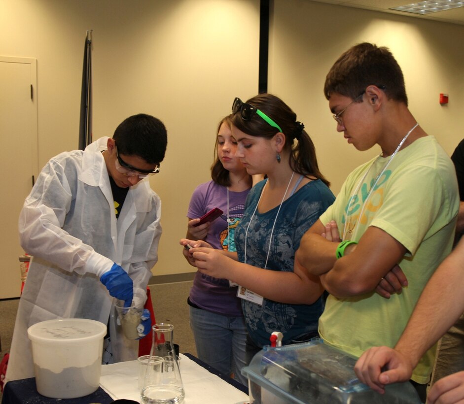 Students at the Army STEM Exposition create test samples using rapid set runway repair cement developed by ERDC. 

