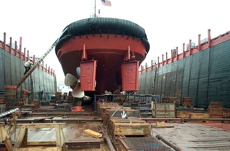 Tugboat in a dry dock for hull painting and propeller work at Caddell Dry Dock & Repair Co. 