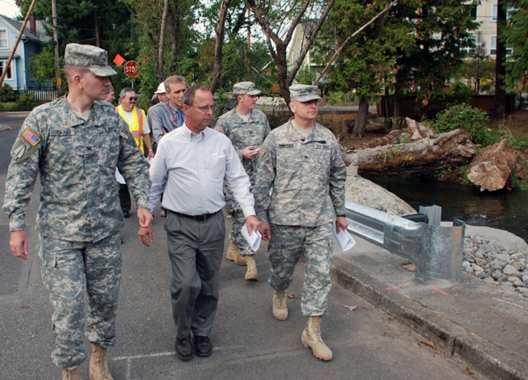 Portland District commander Col. John Eisenhauer (left) and project manager Jim Adams show Northwestern Division commander Brig. Gen. Anthony Funkhouser (pictured as a Colonel before his promotion) the completed first phase of the Crystal Springs Creek and Westmoreland Park Ecosystem Restoration Project in the Sellwood neighborhood of Portland. The $8 million project, partnered with the City of Portland, will improve salmon habitat and passage in an urban setting.