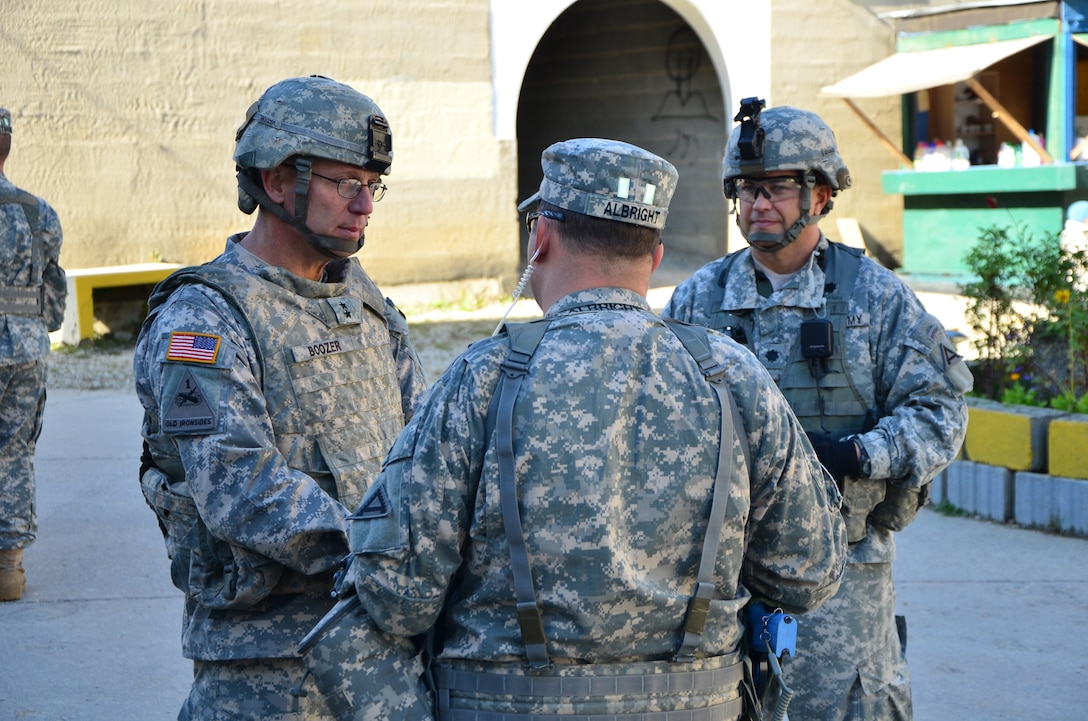 U.S. Army Maj. Gen. James C. Boozer, deputy commanding general and Chief of Staff, U.S. Army Europe, speaks to U.S. Army Maj. Joseph Albright, of the Joint Multinational Readiness Center, during a decisive action training environment exercise, Saber Junction 2012, in Hohenfels, Germany, Oct. 17, 2012. 