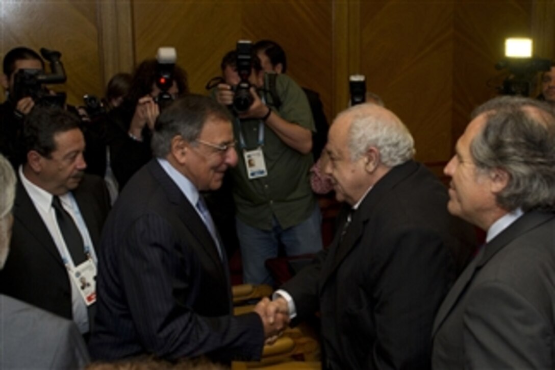 Secretary of Defense Leon E. Panetta, second from left, greets Uruguay's Minister of Defense Eleuterio Fernandez Huidobro, second from right, prior to a meeting at a conference for Defense Ministers in Punta del Este, Uruguay, on Oct 7, 2012.  Panetta is in Uruguay to attend the 10th Conference of Defense Ministers of the Americas as part of a four-day trip to strengthen defense relationships with Western Hemisphere counterparts