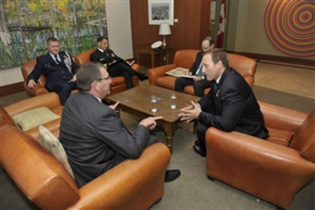 Deputy Secretary of Defense Ashton B. Carter, left, meets informally with Canadian Minister of Defense Peter MacKay, right, at the Ottawa International Airport on Oct. 13, 2012.  Carter will later address the attendees of the North American Forum conference held in Ottawa.  