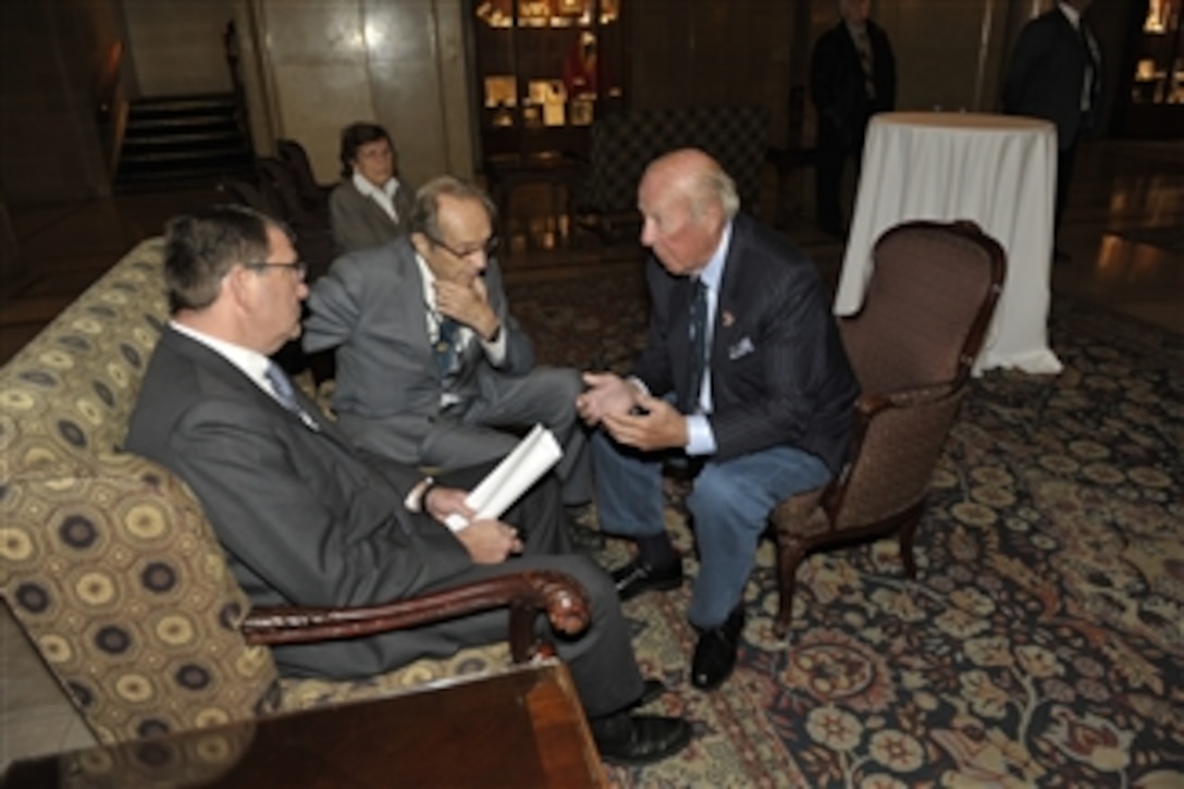 Deputy Secretary of Defense Ashton B. Carter, left, and former Secretary of Defense William Perry listen to former Secretary of State George P. Shultz, right, as he makes a point during a conversation at the North American Forum conference in Ottawa, Canada, on Oct. 13, 2012.  Carter earlier addressed the audience of the conference.  