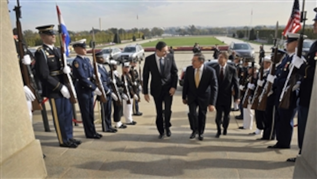 Secretary of Defense Leon E. Panetta, center, escorts Croatia's Minister of Defense Ante Kotromanovic, left, through an honor cordon and into the Pentagon on Oct. 17, 2012.  Panetta and Kotromanovic will meet to discuss national security items of interest to both nations.  