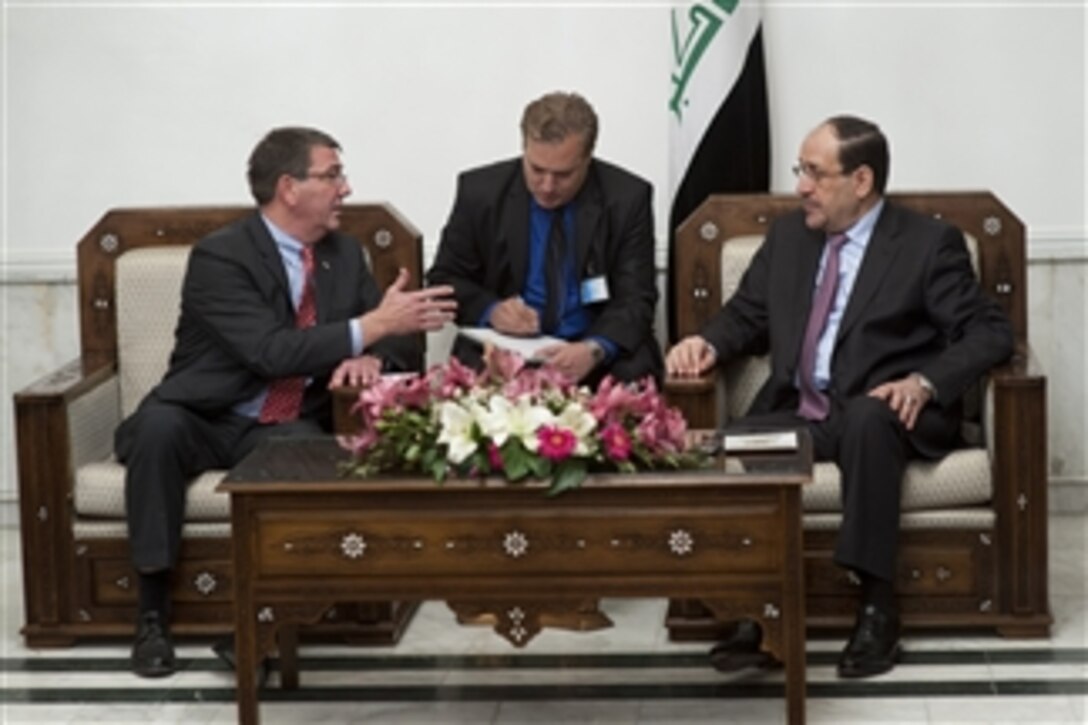 Deputy Secretary of Defense Ashton B. Carter, left, meets with Iraqi Prime Minister Nuri al-Maliki, right, during a visit to Baghdad, Iraq, on Oct. 18, 2012.  Carter is on a seven-day trip to the Middle East to meet with leaders and counterparts in the region.  