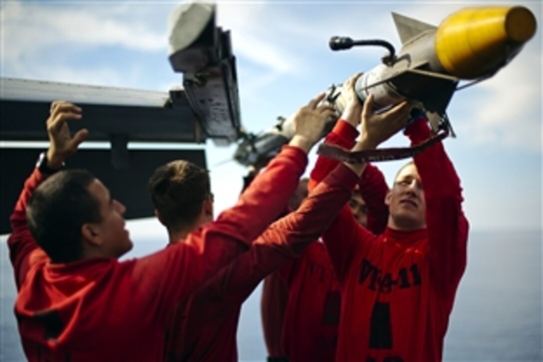 U.S. sailors remove an AIM-9x missile from an F/A-18F Super Hornet on the flight deck of the aircraft carrier USS Enterprise while under way in the Mediterranean Sea, Oct. 13, 2012. The sailors are assigned to Strike Fighter Squadron 11. The Enterprise is deployed to the U.S. 6th Fleet area of responsibility conducting maritime security operations and theater security cooperation efforts.