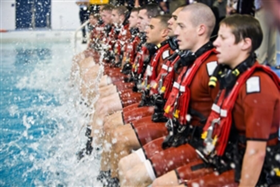 Coast Guardsmen prepare to demonstrate their swimming skills during a public training exercise at the new Rescue Swimmer Training Facility in Elizabeth City, N.C., Oct. 17, 2012. The new building encompasses approximately 50,000-square-feet including a 164-by-82-foot training pool that is 12-feet deep and holds more than one million gallons of water.