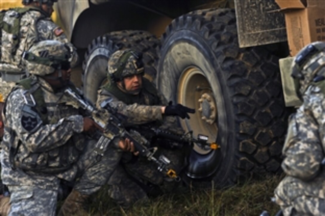 Soldiers provide security while overcoming a ground attack during a joint service field exercise at the Joint Readiness Training Center on Fort Polk, La., Oct. 18, 2012. Service members participating in JRTC 13-01 are educated and evaluated in a simulated combat environment.
