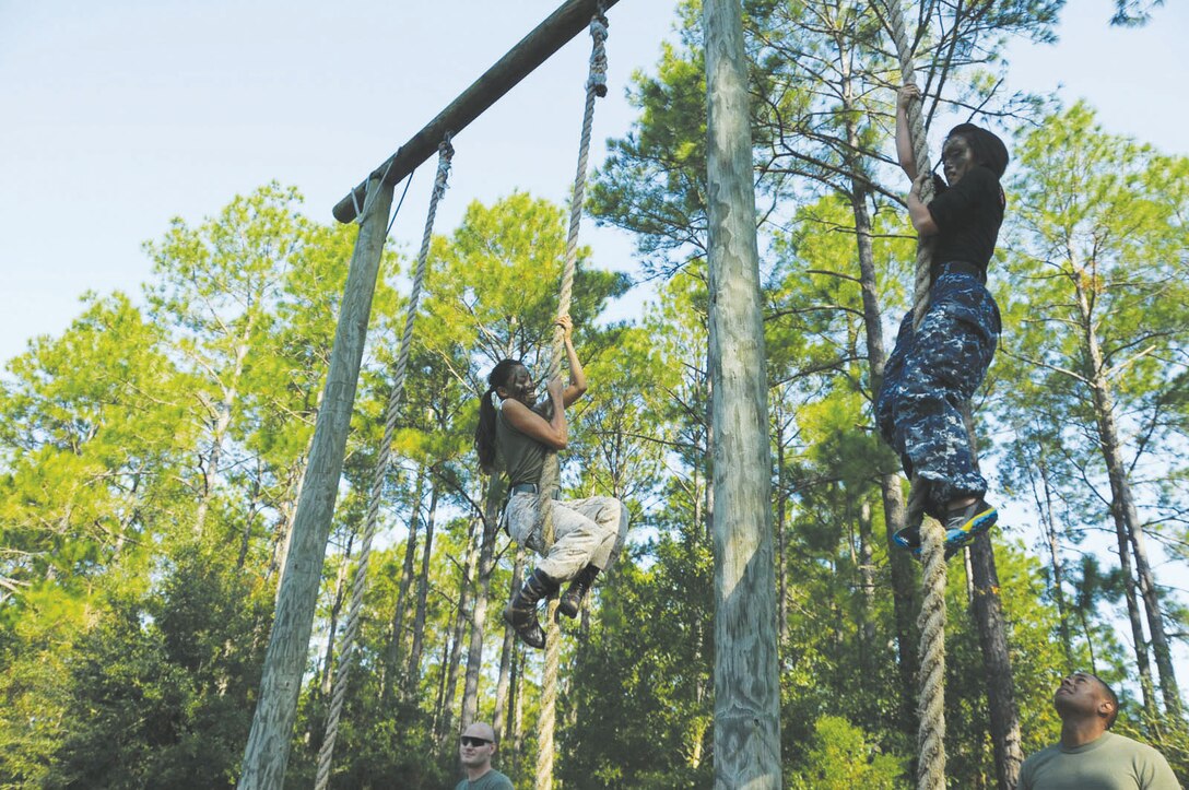 Spouses of Marines and Sailors test their skills in a rope climb during Jane Wayne Day, Oct. 12, at Marine Corps Logistics Base Albany. Jane Wayne Day is designed for spouses and guests of service members to gain a better appreciation for, and understand, military training events and activities. Spouses and guests are afforded an opportunity to be pushed and trained by subject matter experts in different events.
