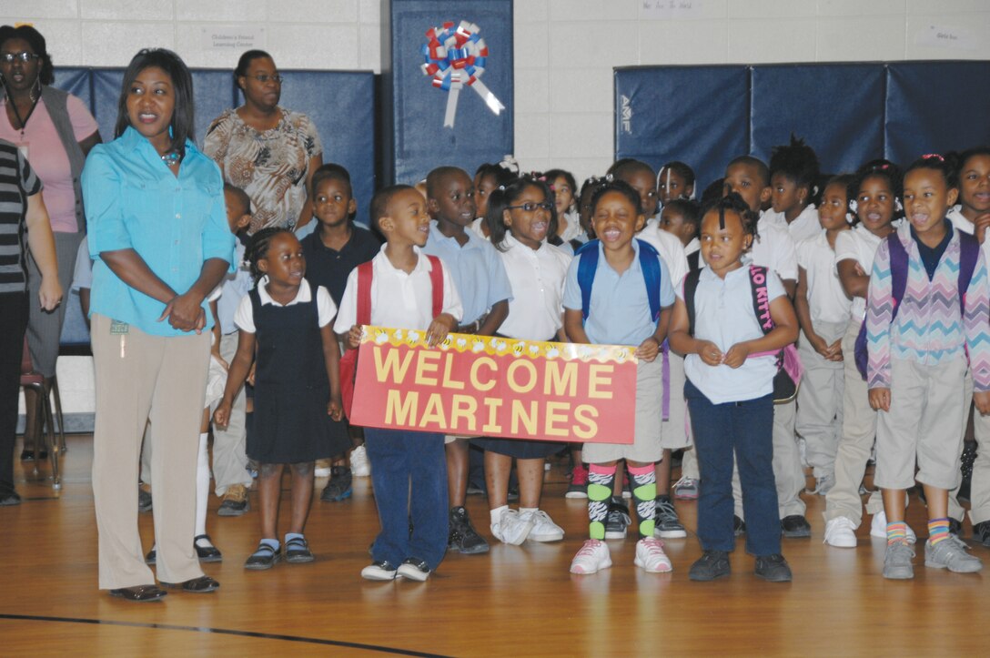 Students at International Studies Elementary Charter School, Albany, greet Marines during the kickoff assembly for the Mentors In Action Program, Monday. More than 25 Marines volunteered to serve as mentors for the remainder of the school year.