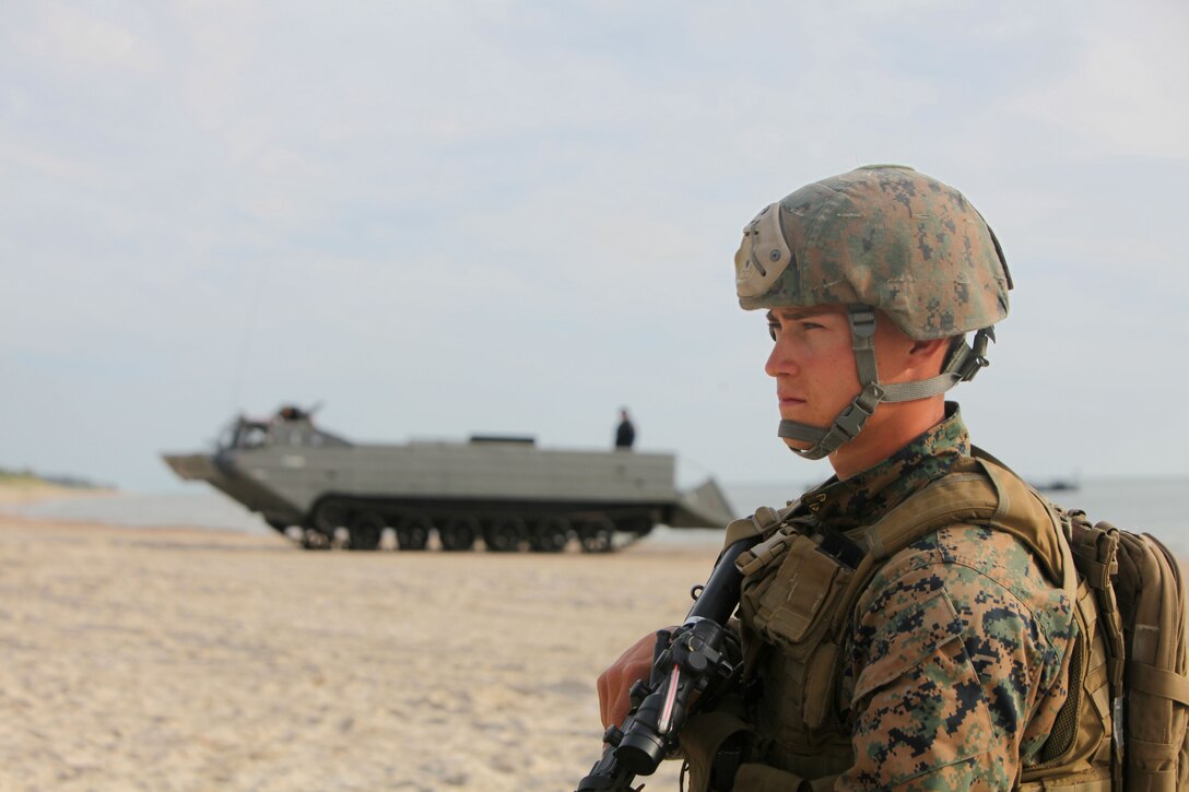 Lance Cpl. Elias Gobble, a reconnaissance Marine with Ground Combat Element, Black Sea Rotational Force 12, surveys the landing site after disembarking a Polish amphibious tractor prior to securing a beachhead during Exercise BALTOPS 2012, June 4. The Marines and sailors of BSRF 12 joined Lithuanian infantry soldiers in the first amphibious landing on Lithuanian soil in 40 years.