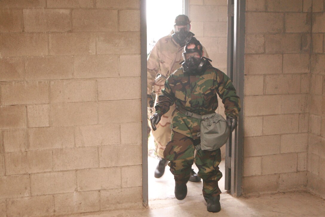 Marines from the 11th MEU’s command element enter the gas chamber during annual gas chamber confidence training here Oct 18. In the chamber, Marines and sailors conducted several exercises including side-straddle hops and head movements to prove that the seal between the gas and the Marine’s faces was working properly.     