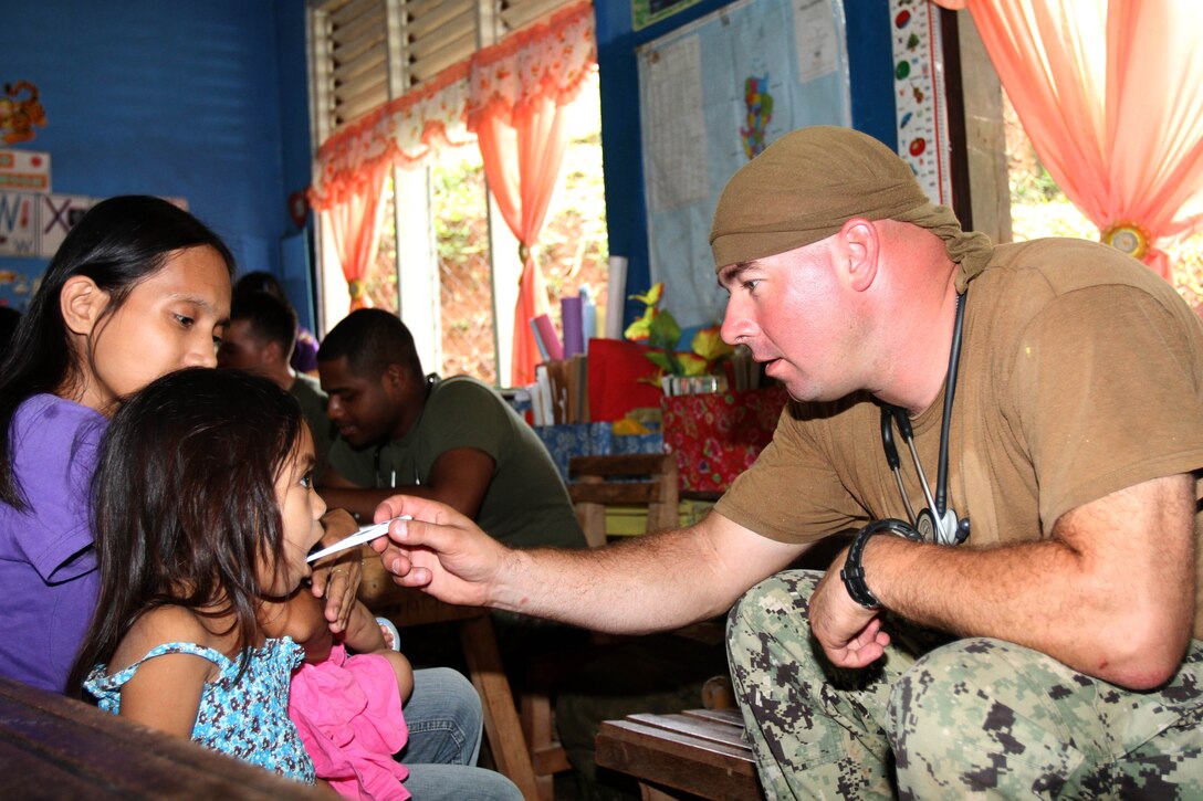 Petty Officer 2nd Class James Green, corpsman with Naval Mobile Construction Battalion 74 checks vital signs during Amphibious Landing Exercise 2013 Here, Oct. 16. PHIBLEX 13 is a bilateral training exercise hosted annually in the Republic of the Philippines to enhance interoperability and readiness of Armed Forces of the Philippines and U.S. Forces the training is designed to prepare both countries' military force for humanitarian service missions as well as strengthen bilateral ties.