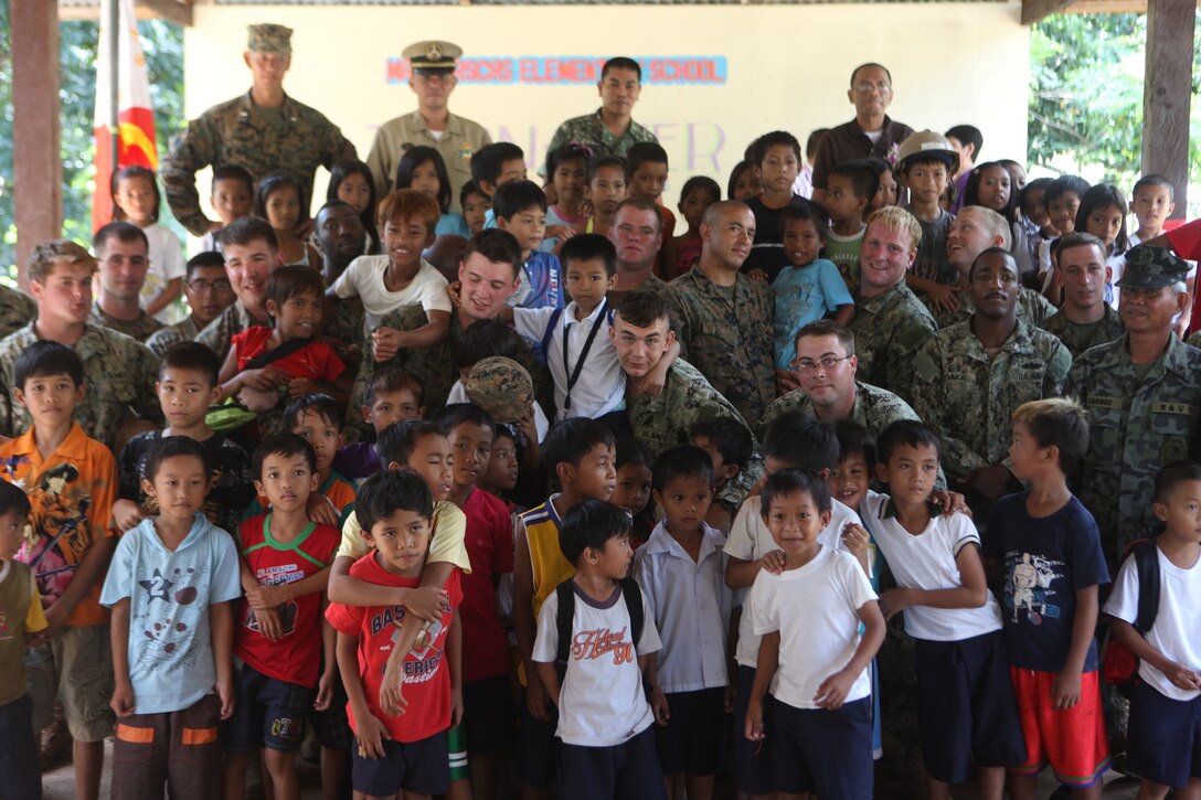 U.S. Marines, Seabees and Philippine Marines and Sailors stand with students of the Macarascas Elementary School children following the ribbon cutting ceremony marking the completion of the MES engineering project here, Oct. 16. The ENCAP construction sites took under two weeks, finishing with two closing ceremonies and ribbon cuttings. The ENCAPs is one of multiple humanitarian civil affairs projects conducted by the 31st MEU throughout the island of Palawan during the Amphibious Landing Exercise in the Philippines. PHIBLEX, now in its 29th iteration, is an annually-scheduled exercise between the U.S. and Philippine forces, aimed at strengthening military-to-military interoperability and bilateral relationships.