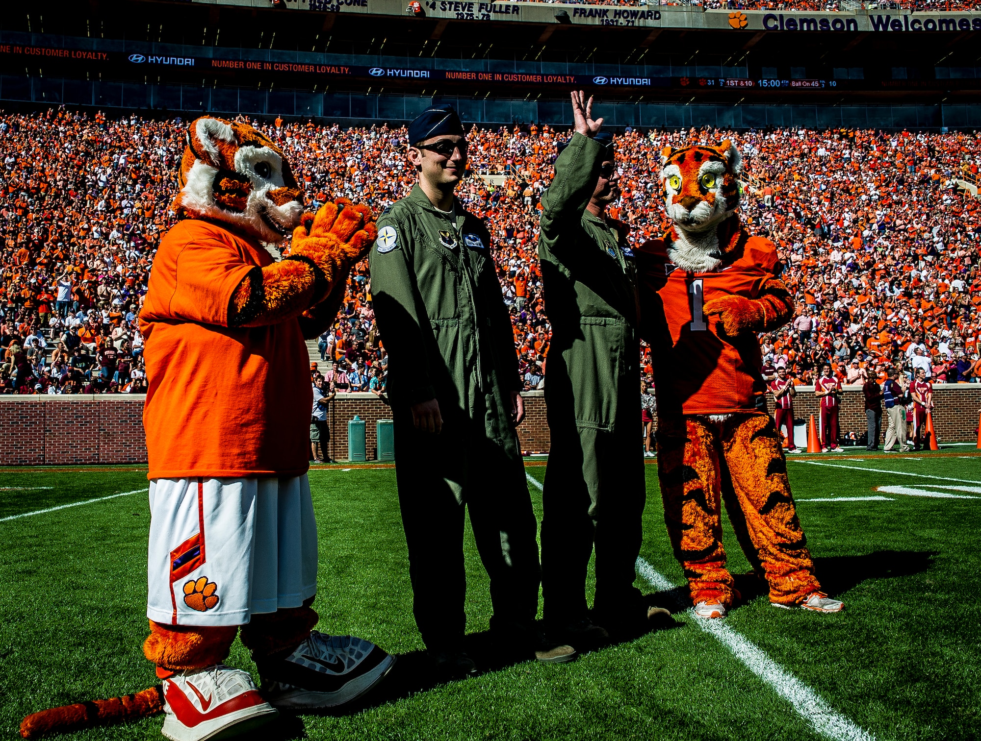 Capt. Justin Kulish (left) and Capt. Michael Polidor (right), B-2 Bomber pilots from Whiteman Air Force Base, Mo., stand with mascots from the Clemson Tigers during a ceremony Oct. 20, 2012, at Memorial Stadium, Clemson S.C. The two pilots were recognized for their efforts providing close-air support during an insurgent ambush of Command Outpost Keating in October 2009. (U.S. Air Force photo/Senior Airman Dennis Sloan) 