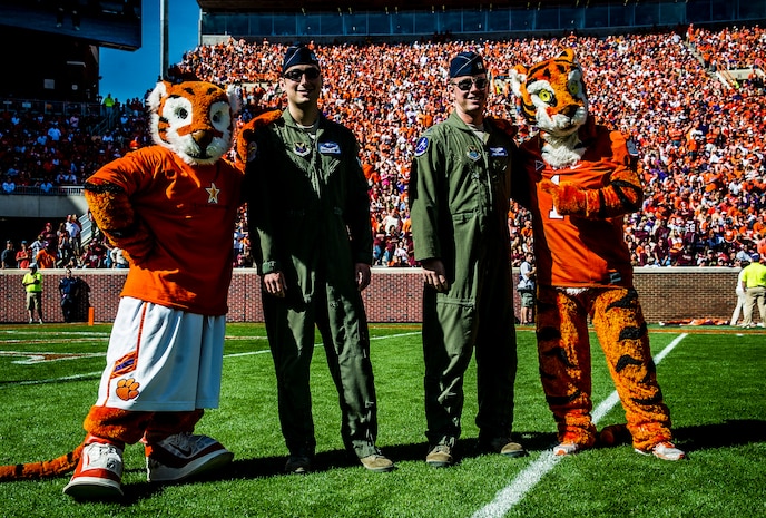 Capt. Justin Kulish (left) and Capt.  Michael Polidor (right), B-2 Bomber pilots from Whiteman Air Force Base, Mo., stand with mascots from the Clemson Tigers during a ceremony Oct. 20, 2012, at Memorial Stadium, Clemson S.C. The two pilots were recognized for their efforts providing close-air support during an insurgent ambush of Command Outpost Keating in October 2009. (U.S. Air Force photo/Senior Airman Dennis Sloan)