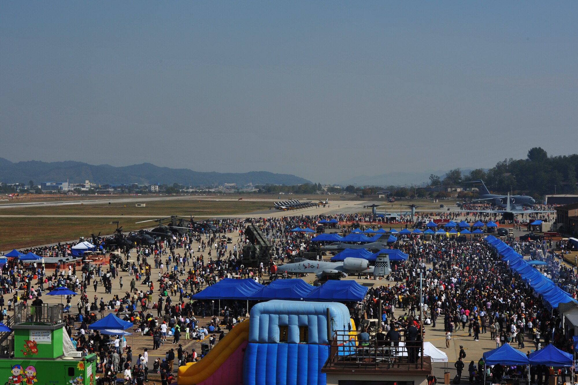 Spectators from across the peninsula pack the flightline for Air Power Day 2012 at Osan Air Base, Republic of Korea, Oct. 20, 2012. Air Power Day 2012 represents an annual opportunity for the United States to showcase its military personnel and unique equipment to a global audience. The airshow presents an opportunity to highlight the relationship between the 51st Fighter Wing and the Republic of Korea through public demonstrations of military equipment and personnel. (U.S. Air Force photo/Staff Sgt. Craig Cisek)