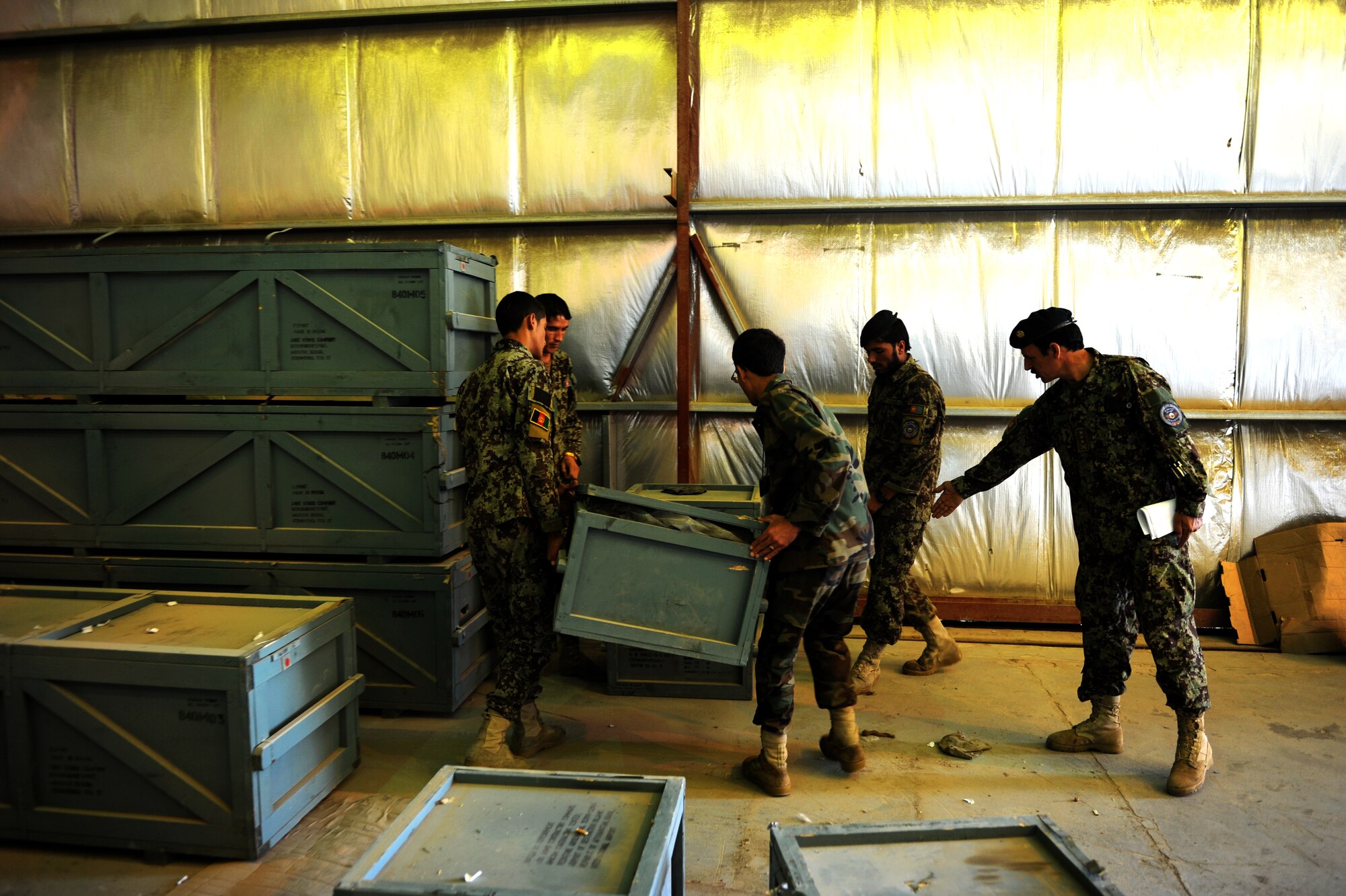 Afghan air force soldiers at the Kabul, Afghanistan, International Airport relocate crates after an inventory was done on the parts inside. Over the last several months, the Afghan air force has been conducting a project involving the inventory of more than 47,000 parts. Once the inventory is complete, the parts will be distributed to other bases in Afghanistan. (U.S. Air Force photo Staff Sgt. Melissa K. Mekpongsatorn)