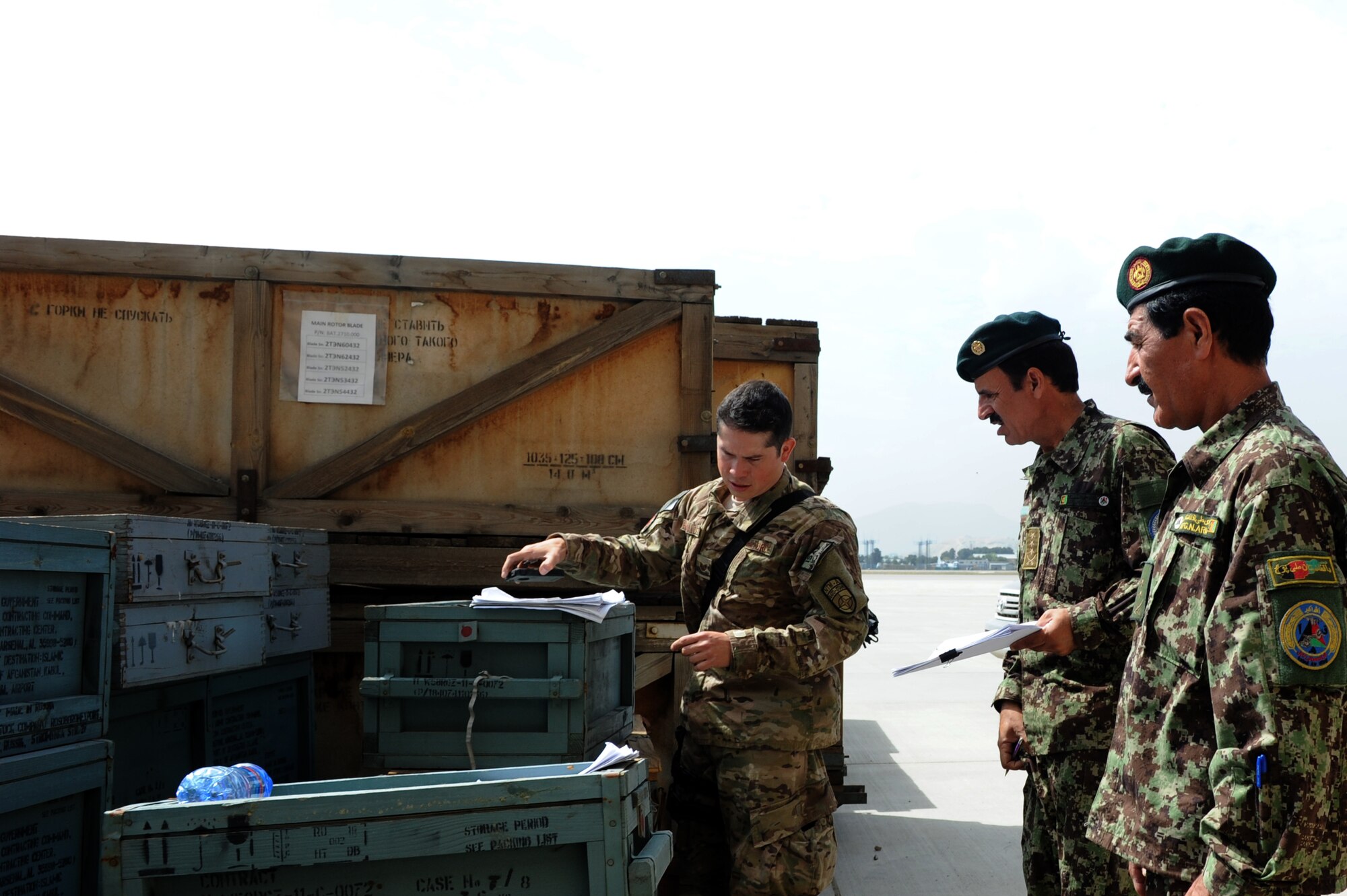 Tech Sgt. Luiggi Hernandez, 438th Air Expeditionary Wing air transportation advisor, and two Afghan air force soldiers inventory MI-17 parts at the Kabul, Afghanistan, International Airport.  As inventory took place, Hernandez took the opportunity to train the AAF soldiers on supply and accountability procedures. (U.S. Air Force photo by Staff Sgt. Melissa K. Mekpongsatorn)