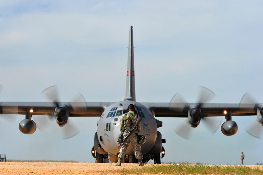 FORT POLK, La. -- An aircraft maintenance technician assigned to the 570th Contingency Response Group from Travis Air Force Base, Calif., prepares to guide a C-130J Hercules out of his parking spot at Geronimo Landing Zone, Fort Polk La., Oct 17, 2012.   The CRG was supporting Joint Readiness Training Center Exercise Decisive Action. The exercise includes emphasis on joint forcible entry, phased deployment with an airborne parachute operation, a combined noncombatant evacuation, combine arms maneuver, wide area security, unconventional warfare and unified land operations in a joint, interagency, intergovernmental and multinational environment. (U.S. Air Force photo by Tech. Sgt.  Parker Gyokeres) (Released)
