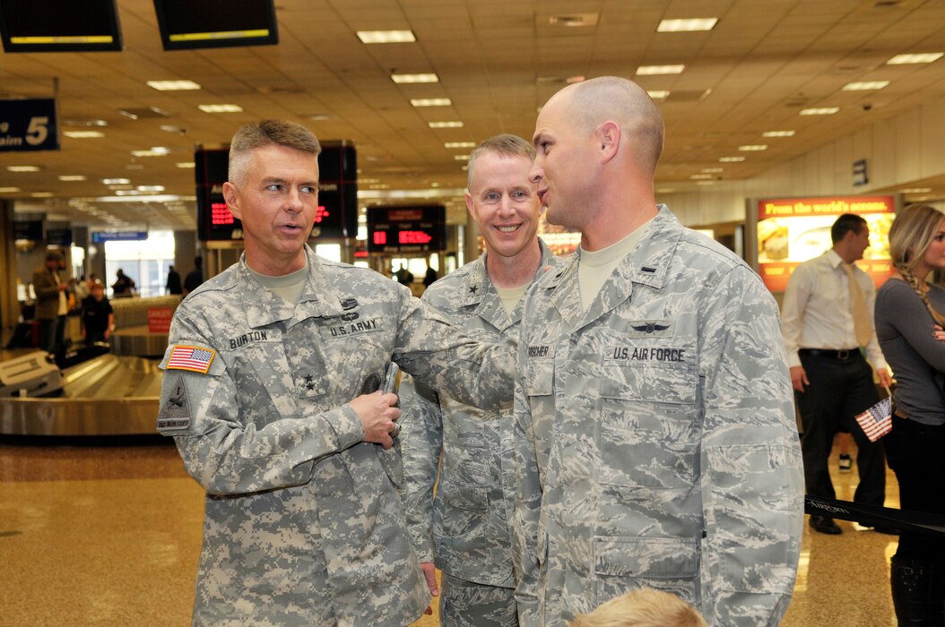 Brig. Gen. Jefferson Burton welcomes 1st Lt. Brian Herrscher, 130th Engineering Installation Squadron, as he arrives home from a six-month deployment to the Middle East at the Salt Lake City International Airport on Sunday Oct. 21, 2012. Herrscher, along with 13 others from the 130th EIS were deployed to the Middle East in support of Operation Enduring Freedom. (U.S. Air Force Photo by Tech. Sgt. Jeremy Giacoletto-Stegall/Released)