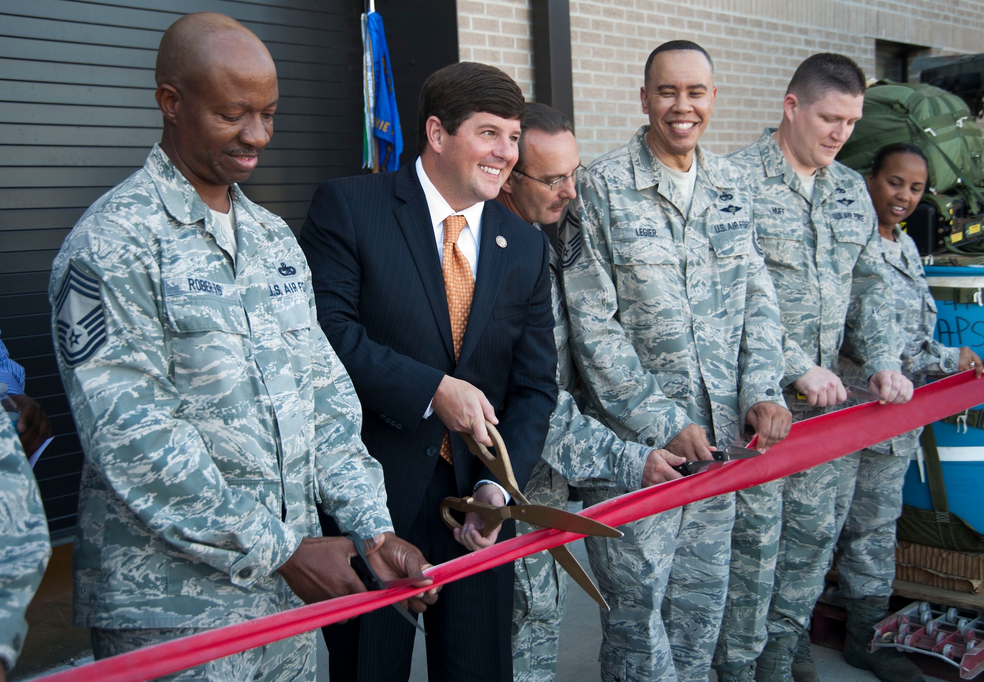 KEESLER AIR FORCE BASE, Miss. – Congressman Steven M. Palazzo, U.S. Representative, fourth congressional district of Mississippi, prepares to cut the ribbon dedicating the newly-completed 41st Aerial Port Squadron building here Oct. 20 along with other members of the 41st APS. The $8.5 million, 30,000 square foot facility provides the 41st APS Air Force Reserve members with a purpose-built environment designed to train and work in supporting the mission of the 41st and the 403rd Wing here at Keesler AFB. (U.S. Air Force photo/Tech. Sgt. Ryan Labadens)