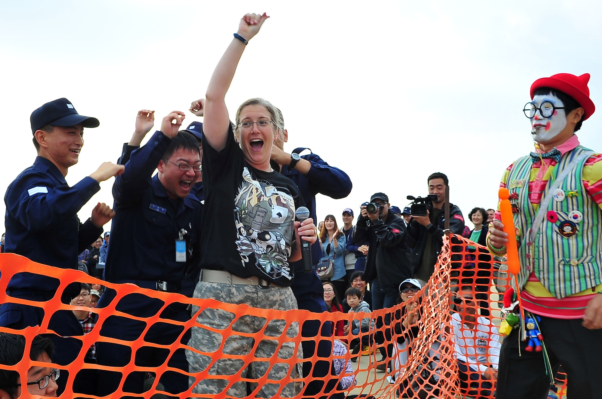 Master Sgt. Margaret Hood, lead vocalist of the 8th U.S. Army Band energizes a group of Airmen during her performance of Redneck Woman by country singer Gretchen Wilson at Osan Air Base, Republic of Korea, Oct. 21, 2012. The 8th Army Band performed a variety of songs to entertain the crowd during Air Power Day, which featured an assortment of Korean and American military equipment and aerial displays. (U.S. Air Force photo/Tech. Sgt. Raymond Mills)