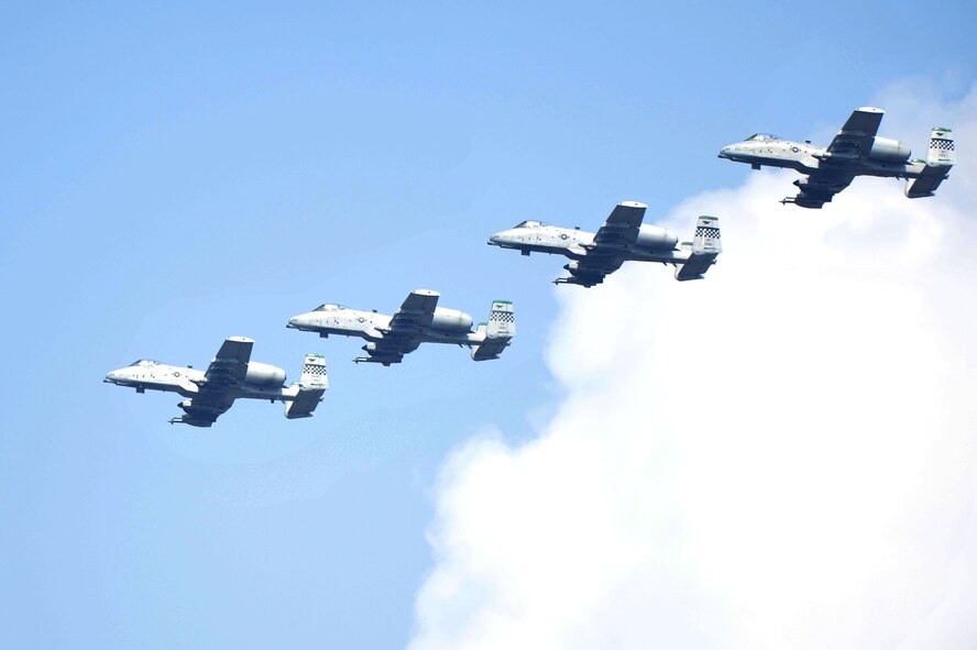 A-10 Thunderbolt IIs from the 25th Fighter Squadron perform a flyby for Air Power Day 2012 at Osan Air Base, Republic of Korea, Oct. 21, 2012. Air Power Day 2012 represents an annual opportunity for the United States to showcase its military personnel and unique equipment to a global audience. (U.S. Air Force photo/Staff Sgt. Craig Cisek)