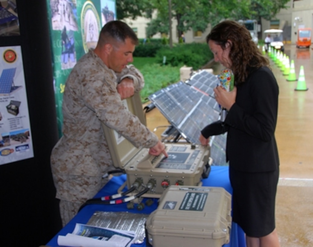 Major Jesse Hardin, Marine Corps Systems Command's (MCSC) Energy Systems Branch Head, talks with a visitor at MCSC's Marine Corps Expeditionary Energy display in the Pentagon Courtyard during the Pentagon Energy Security Event in early October.