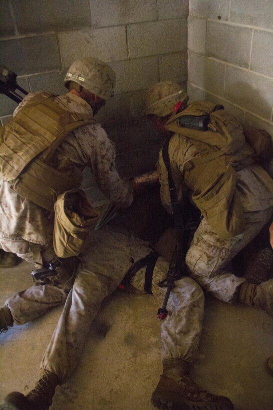 Marines of Company K, Battalion Landing Team (BLT) 3/2, currently reinforcing the 26th Marine Expeditionary Unit (MEU), practice dealing with a simulated casualty during the mechanized raid course at Camp Lejeune, N.C., Oct. 10, 2012. BLT 3/2 is one of the three reinforcements of 26th MEU, which is slated to deploy in 2013.