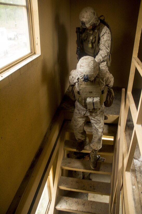Marines of Company K, Battalion Landing Team(BLT) 3/2, currently reinforcing the 26th Marine Expeditionary Unit (MEU), move an enemy prisoner of war downstairs during the mechanized raid course at Camp Lejeune, N.C., Oct. 10, 2012. BLT 3/2 is one of the three reinforcements of 26th MEU, which is slated to deploy in 2013.
